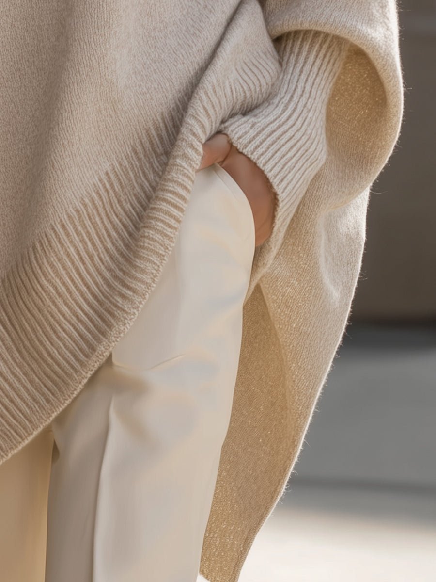 Women's oversized sweater in beige with an asymmetrical hem, made from a cozy wool blend, perfect for stylish layering and comfort in cooler weather. 4