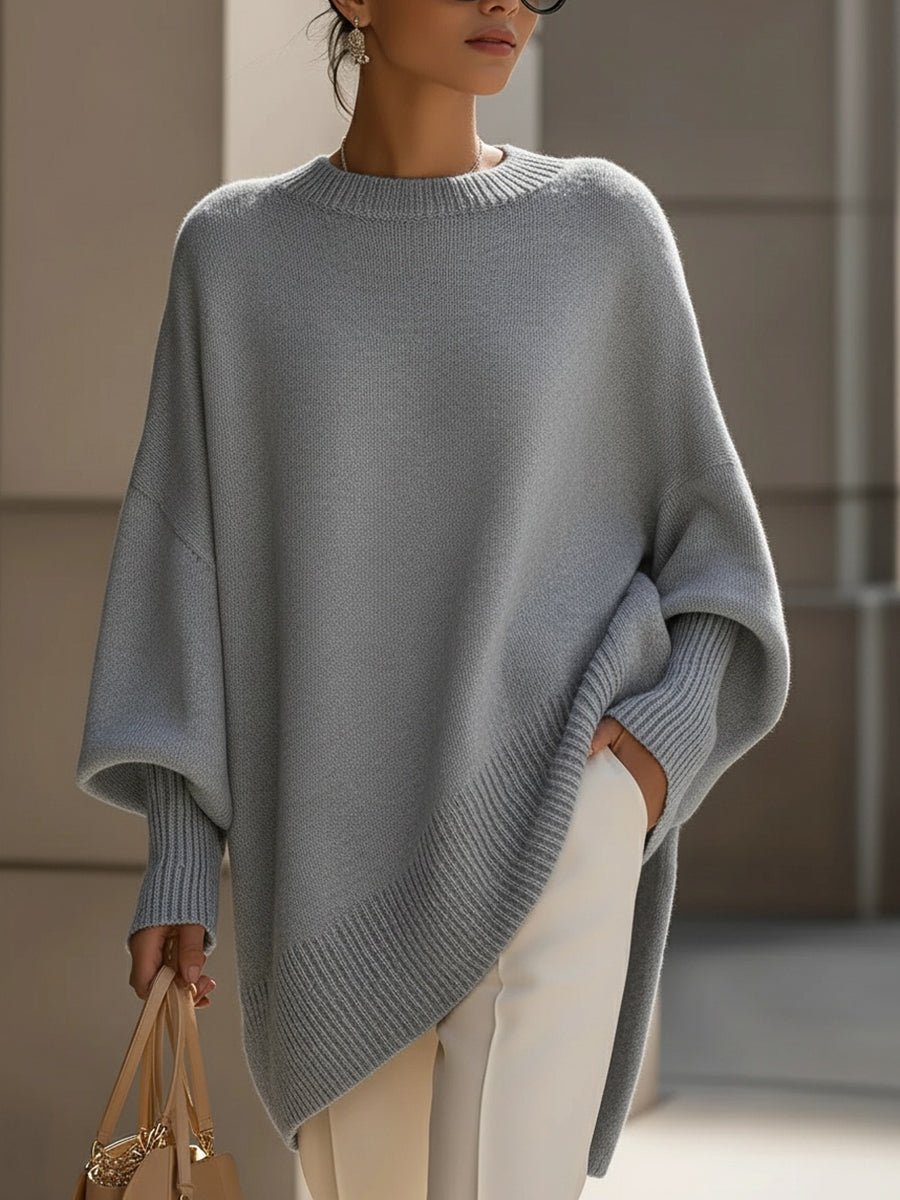Women's oversized sweater in beige with an asymmetrical hem, made from a cozy wool blend, perfect for stylish layering and comfort in cooler weather. 8