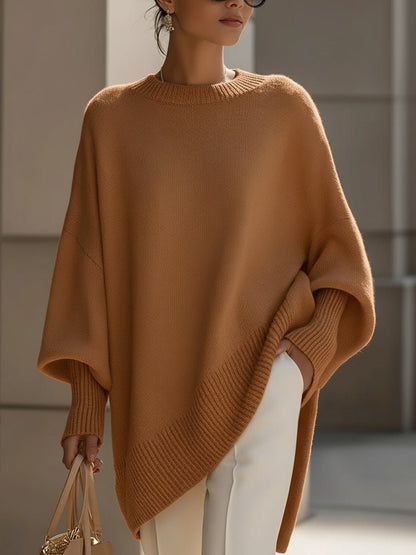 Women's oversized sweater in beige with an asymmetrical hem, made from a cozy wool blend, perfect for stylish layering and comfort in cooler weather. 7