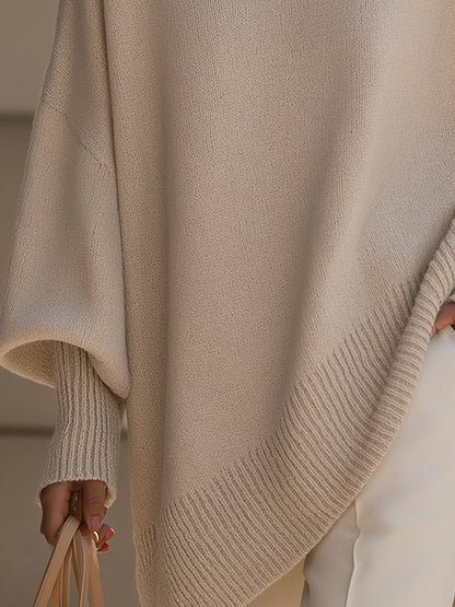 Women's oversized sweater in beige with an asymmetrical hem, made from a cozy wool blend, perfect for stylish layering and comfort in cooler weather. 2