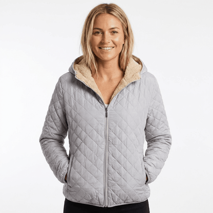 Women's quilted jacket featuring a fleece-lined hood and zip-up closure, designed for warmth and style, perfect for winter wear. 9