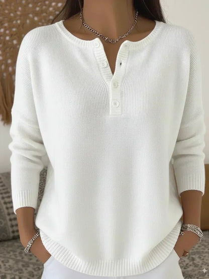 Women's cream ribbed knitted jumper featuring a stylish Henley neckline and side slits, designed for a relaxed fit. 5