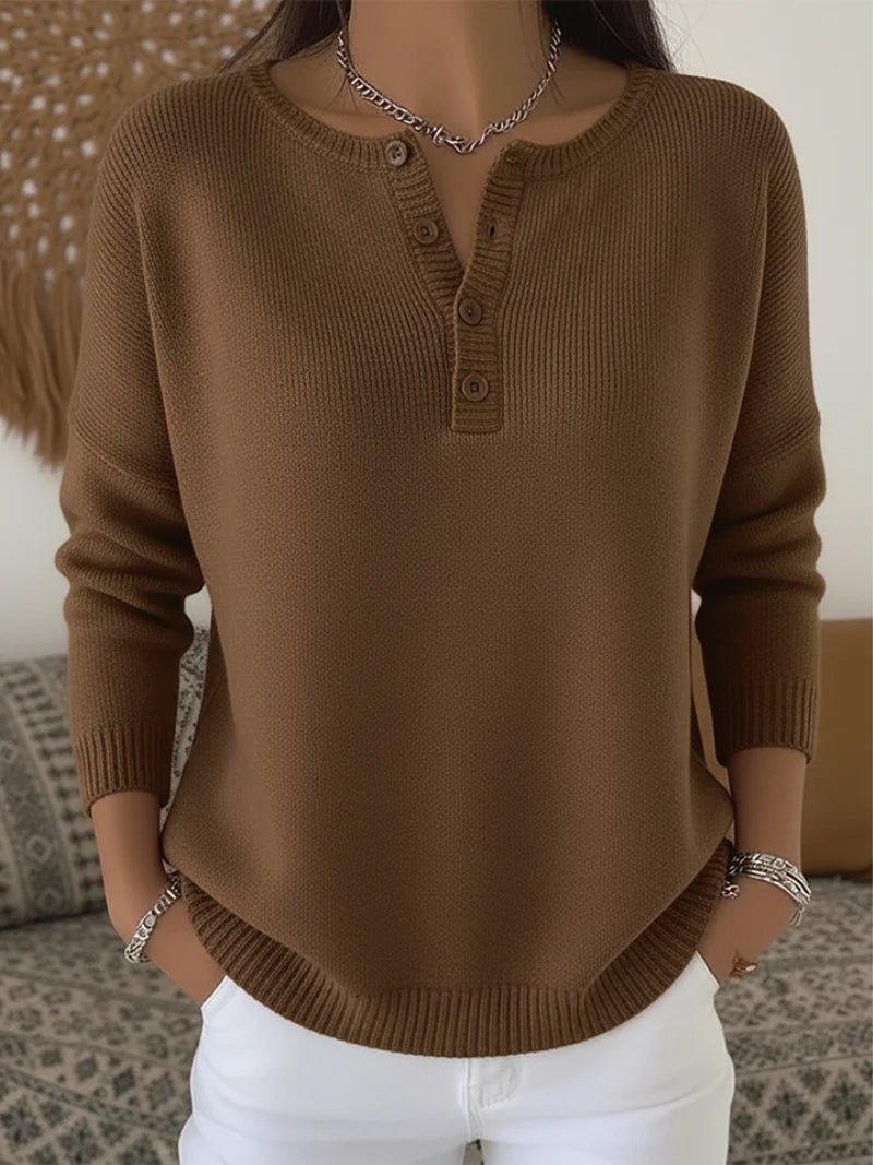 Women's cream ribbed knitted jumper featuring a stylish Henley neckline and side slits, designed for a relaxed fit. 1