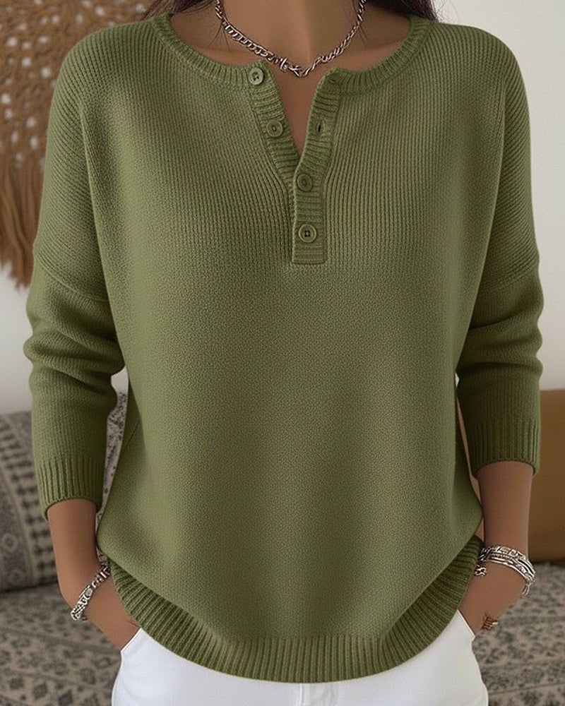 Women's cream ribbed knitted jumper featuring a stylish Henley neckline and side slits, designed for a relaxed fit. 0