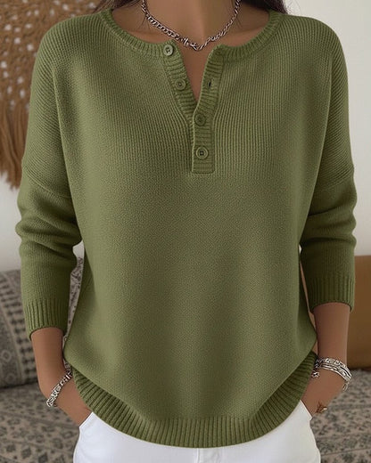 Women's cream ribbed knitted jumper featuring a stylish Henley neckline and side slits, designed for a relaxed fit. 0
