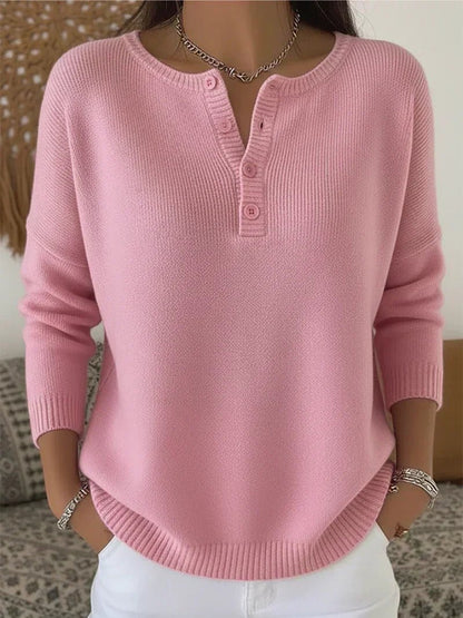 Women's cream ribbed knitted jumper featuring a stylish Henley neckline and side slits, designed for a relaxed fit. 4