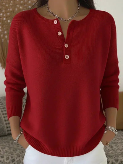 Women's cream ribbed knitted jumper featuring a stylish Henley neckline and side slits, designed for a relaxed fit. 2