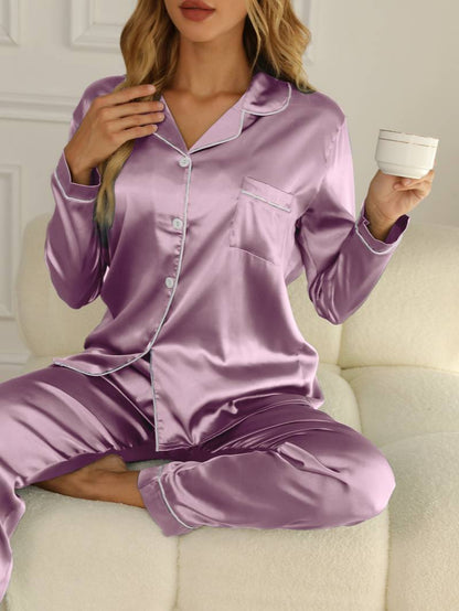 Women's satin pajama set featuring a button-up blouse and long trousers, designed for elegant sleepwear and year-round comfort. 0