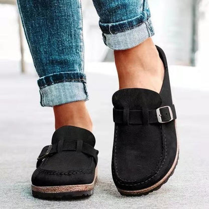 Women's black slip-on loafers featuring a modern buckle design, cushioned sole, and platform for enhanced comfort and style. 2