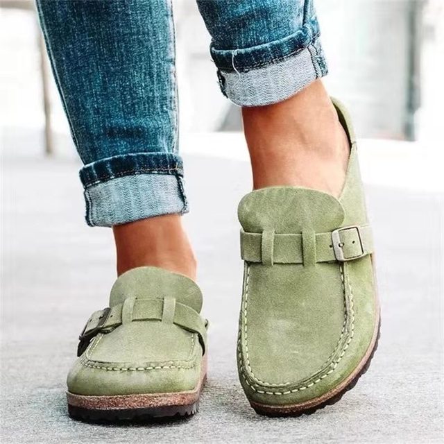 Women's black slip-on loafers featuring a modern buckle design, cushioned sole, and platform for enhanced comfort and style. 4