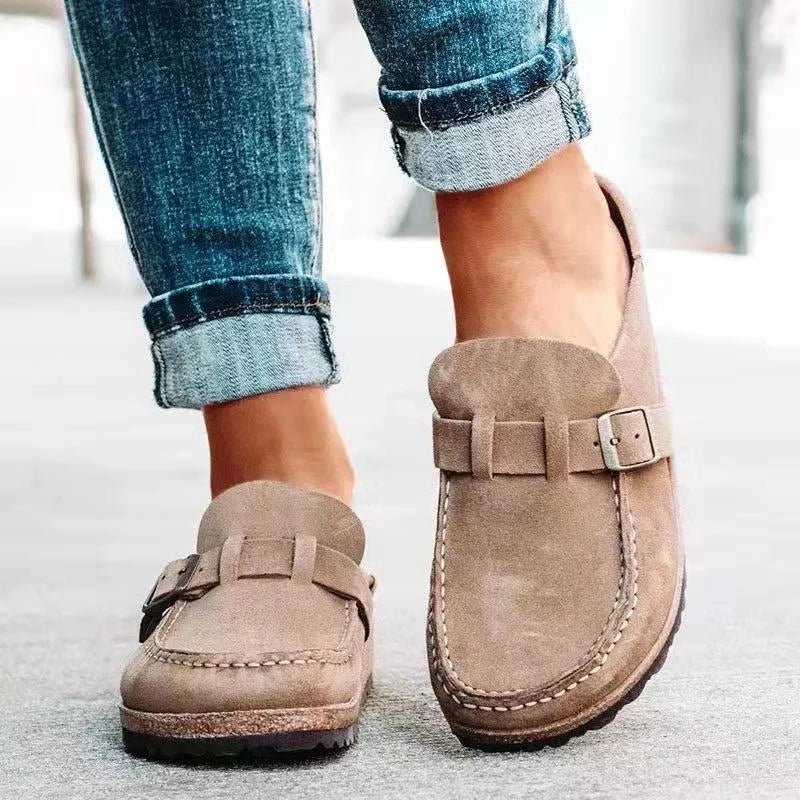 Women's black slip-on loafers featuring a modern buckle design, cushioned sole, and platform for enhanced comfort and style. 0