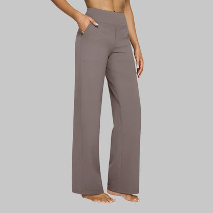 Women's stretch pants featuring a high waist design and deep pockets, crafted for comfort with wrinkle-free fabric, perfect for casual outings and workouts. 0