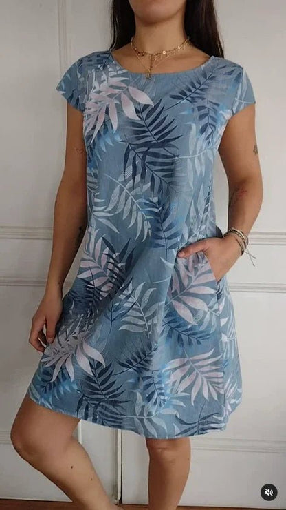 Women's summer dress featuring a vibrant botanical print, designed with convenient pockets, made from a lightweight cotton-linen blend for a relaxed fit, perfect for warm 11
