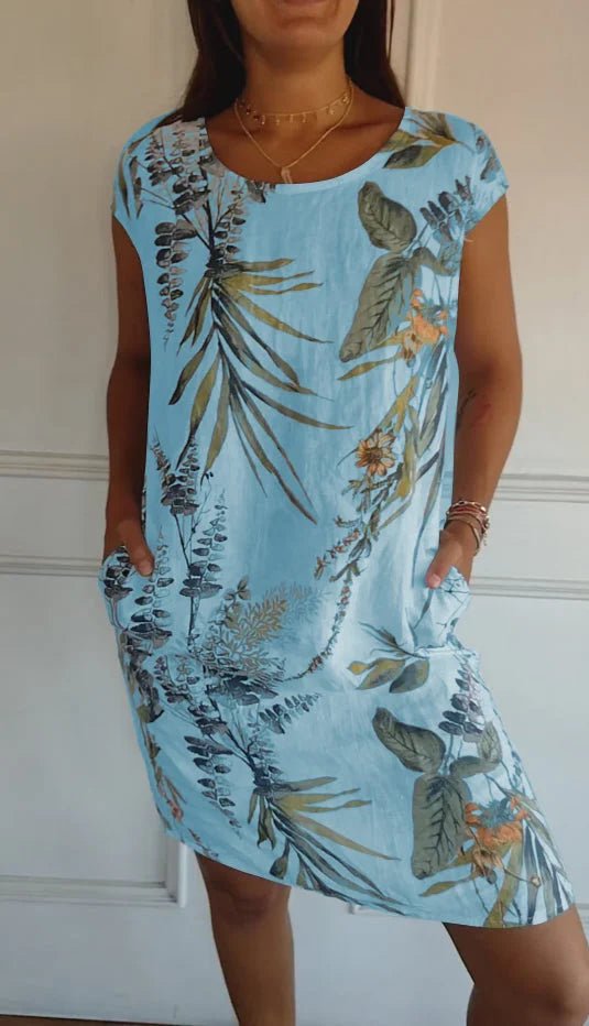 Women's summer dress featuring a vibrant botanical print, designed with convenient pockets, made from a lightweight cotton-linen blend for a relaxed fit, perfect for warm 7