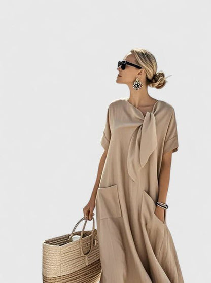 Womens summer dress featuring a chic neck tie and pockets, designed with elegant lightweight white fabric, perfect for warm weather outings. 3