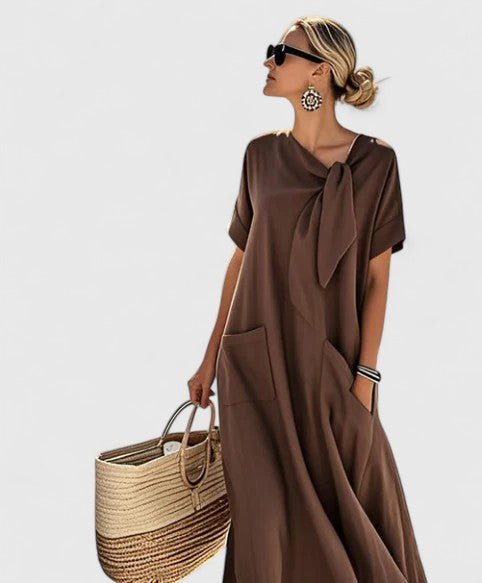 Womens summer dress featuring a chic neck tie and pockets, designed with elegant lightweight white fabric, perfect for warm weather outings. 1