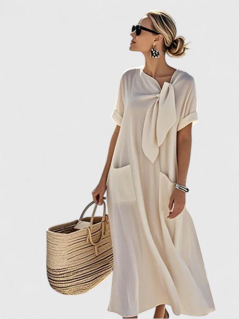 Womens summer dress featuring a chic neck tie and pockets, designed with elegant lightweight white fabric, perfect for warm weather outings. 2
