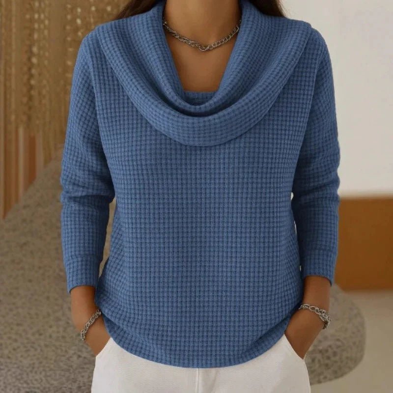 Women's blue sweater featuring a cowl neck design, made from soft waffle knit fabric for cozy warmth, with an elegant flowing fit perfect for stylish layering. 0