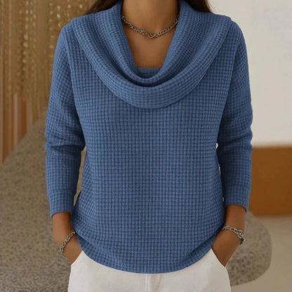 Women's blue sweater featuring a cowl neck design, made from soft waffle knit fabric for cozy warmth, with an elegant flowing fit perfect for stylish layering. 0