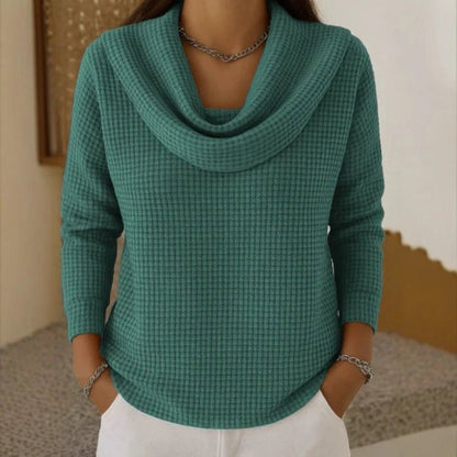 Women's blue sweater featuring a cowl neck design, made from soft waffle knit fabric for cozy warmth, with an elegant flowing fit perfect for stylish layering. 2
