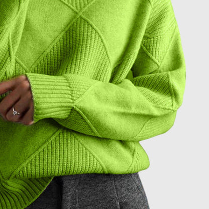Women’s rose-colored sweater featuring a stylish geometric pattern and a cozy turtleneck design, perfect for comfortable layering in cooler weather. 7