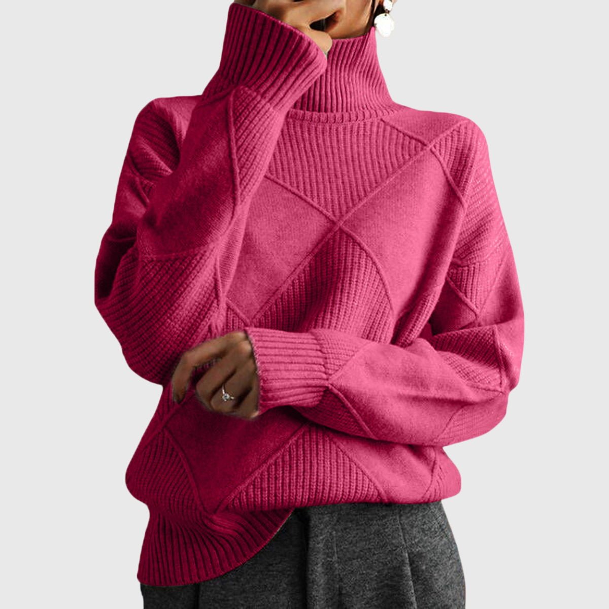 Women’s rose-colored sweater featuring a stylish geometric pattern and a cozy turtleneck design, perfect for comfortable layering in cooler weather. 0