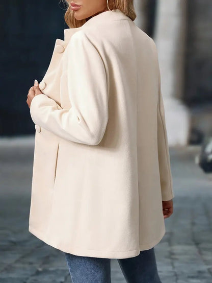 Women's black mid-length trench coat featuring a stylish stand collar and button front, complete with convenient side pockets for a chic and functional outerwear option. 3