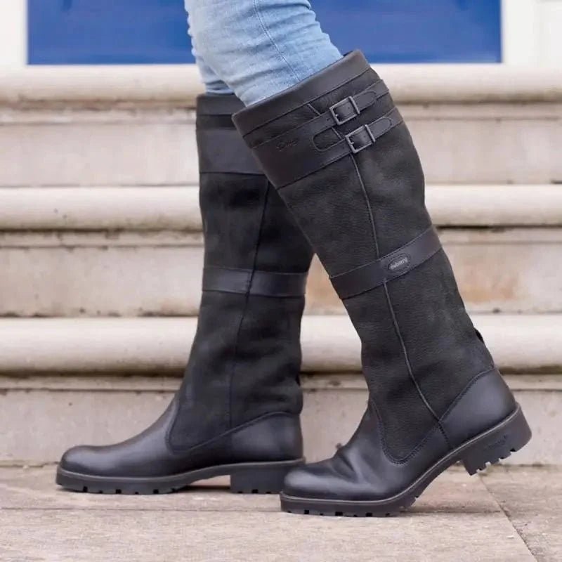 Women's waterproof knee-high boots featuring a stylish double buckle design and an easy pull-on style, perfect for all-weather wear. 1