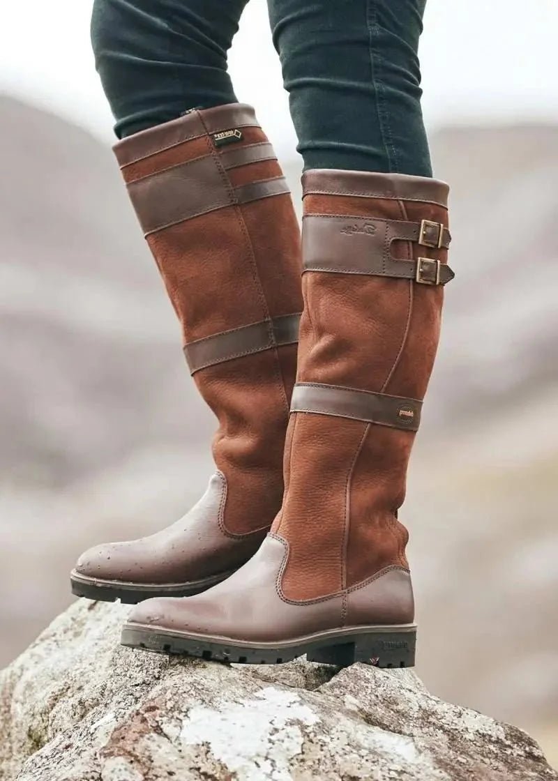 Women's waterproof knee-high boots featuring a stylish double buckle design and an easy pull-on style, perfect for all-weather wear. 2
