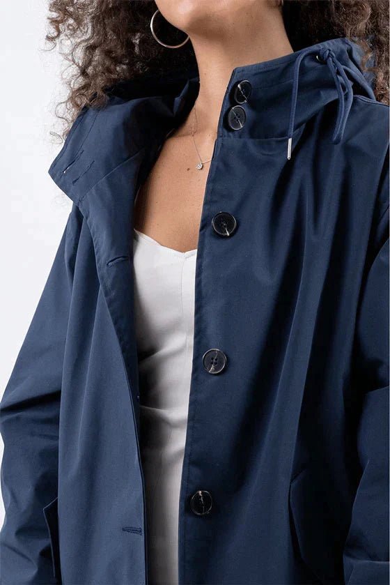 Women's lightweight waterproof rain jacket featuring an adjustable hood, perfect for outdoor adventures in wet weather. 8