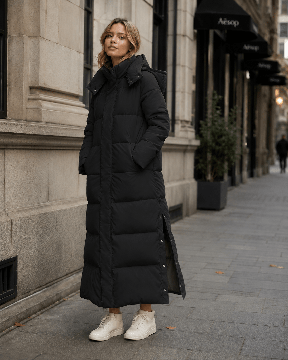 Women's windproof winter jacket featuring an extended length and relaxed fit, designed for durability and warmth in cold weather conditions. 1