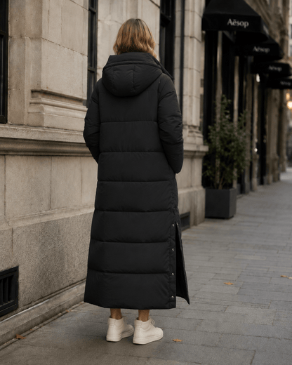Women's windproof winter jacket featuring an extended length and relaxed fit, designed for durability and warmth in cold weather conditions. 4