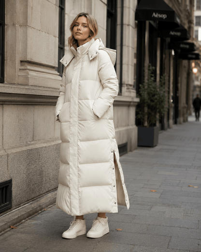 Women's windproof winter jacket featuring an extended length and relaxed fit, designed for durability and warmth in cold weather conditions. 0