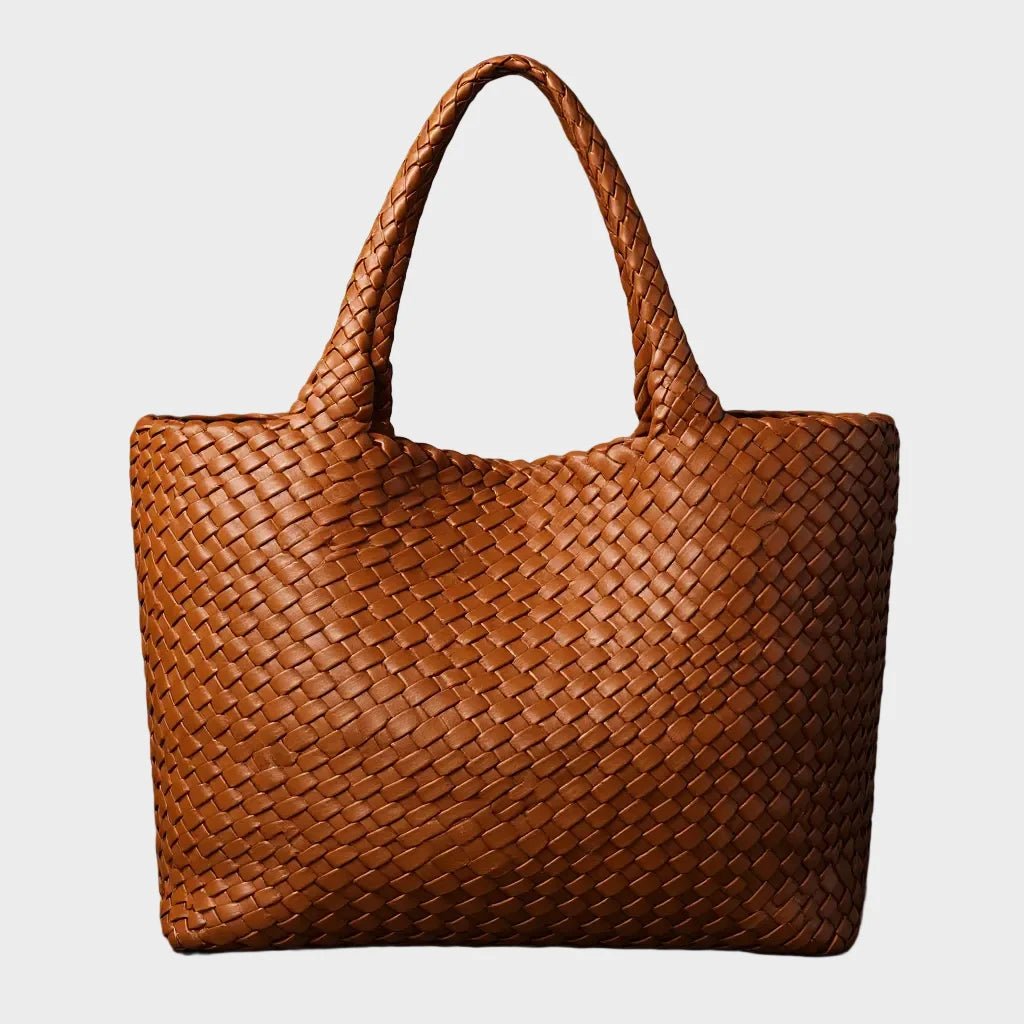 Woven leather tote bag featuring a spacious interior and comfortable handles, designed for everyday use with a timeless aesthetic. 0